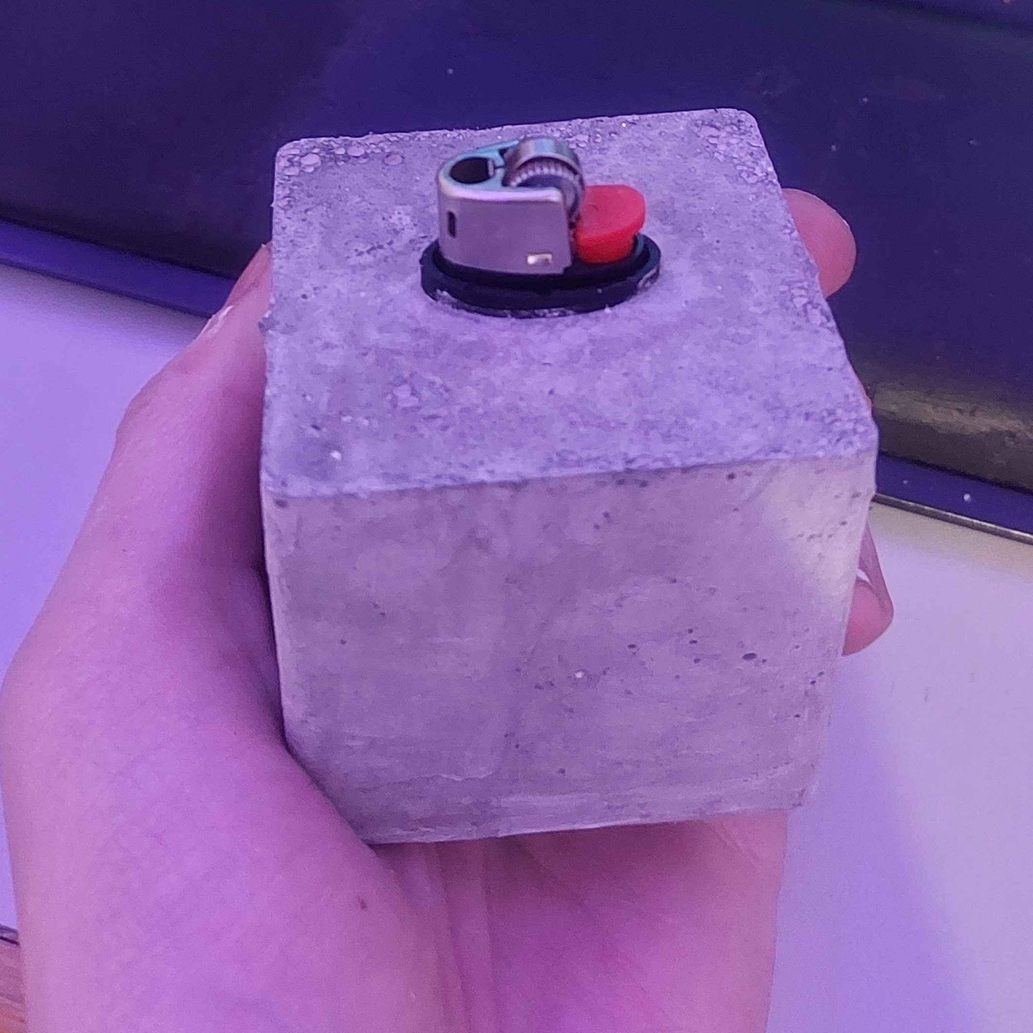 Picture showing v3 of The Heavier, a lighter encased in concrete.